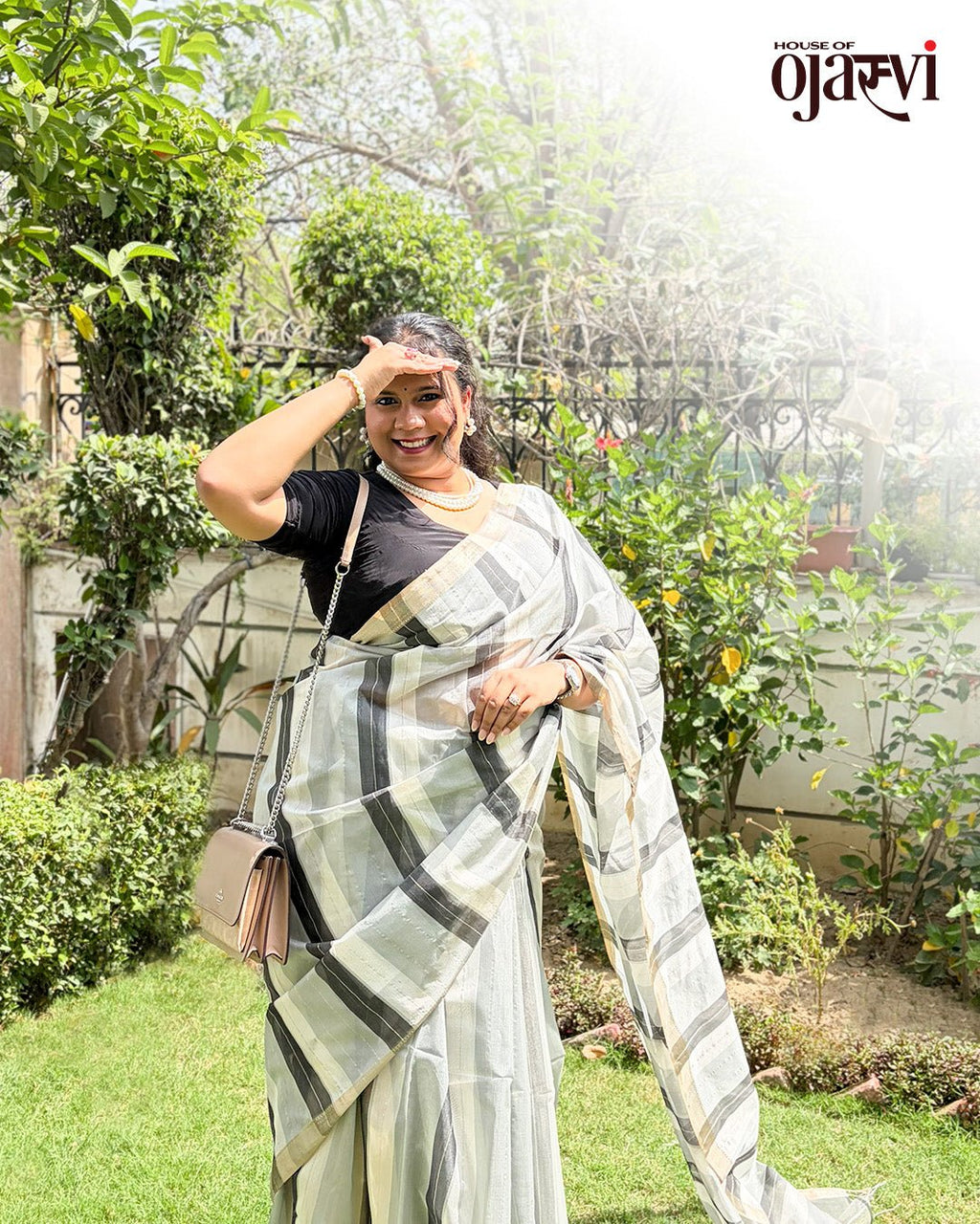 Close-up view of the fine pleats and lustrous weave texture of the black and white checked Maheshwari saree.