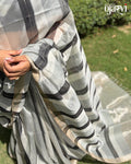 Model wearing the black and white checked handwoven Maheshwari saree outdoors by House of Ojasvi.