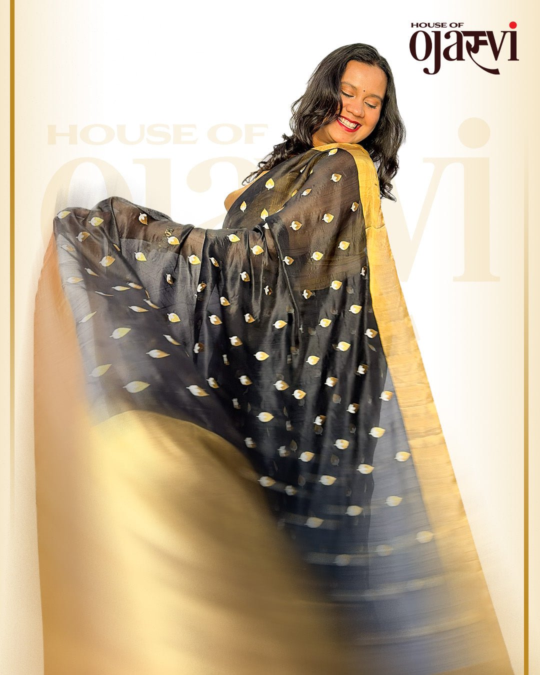 Model twirling to showcase the sheer, lightweight texture of the black Chanderi saree with delicate zari butis.