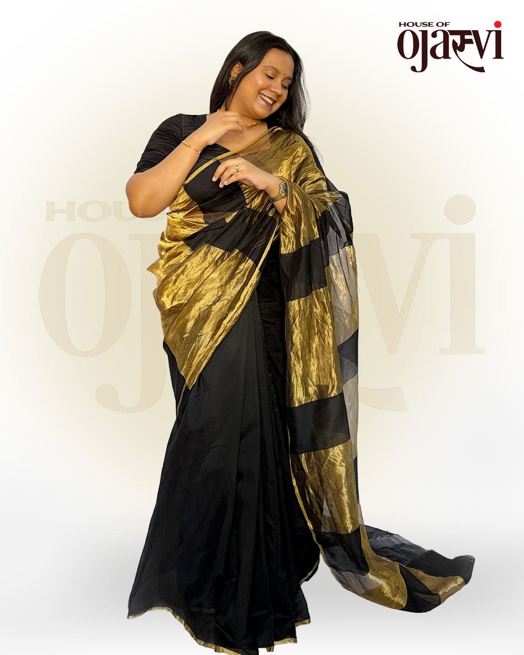 Full-length standing view of the black Chanderi saree showing the elegant drape and grand golden striped pallu.