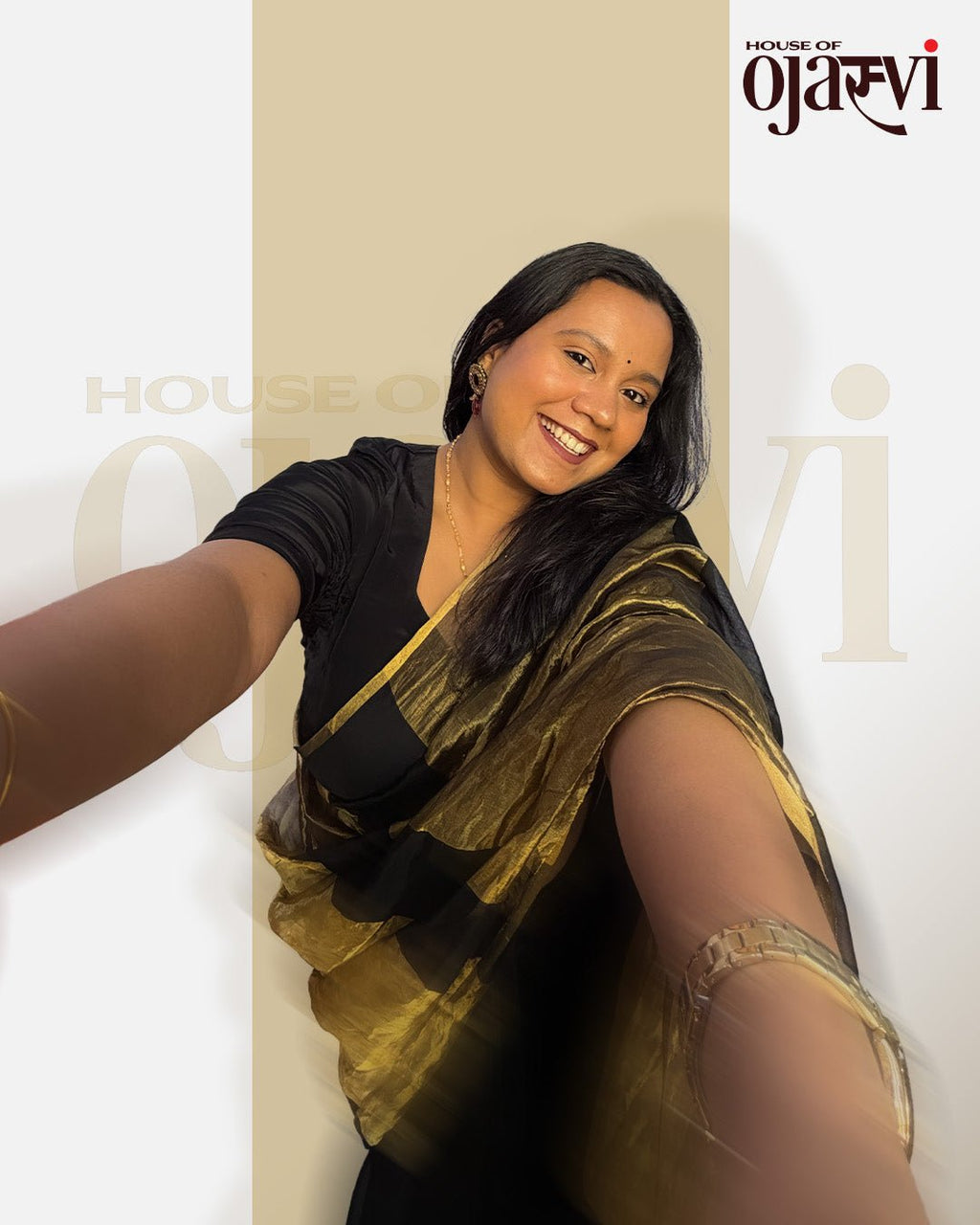 Close-up selfie style shot of the elegant black Chanderi saree with bold golden zari stripes by House of Ojasvi.