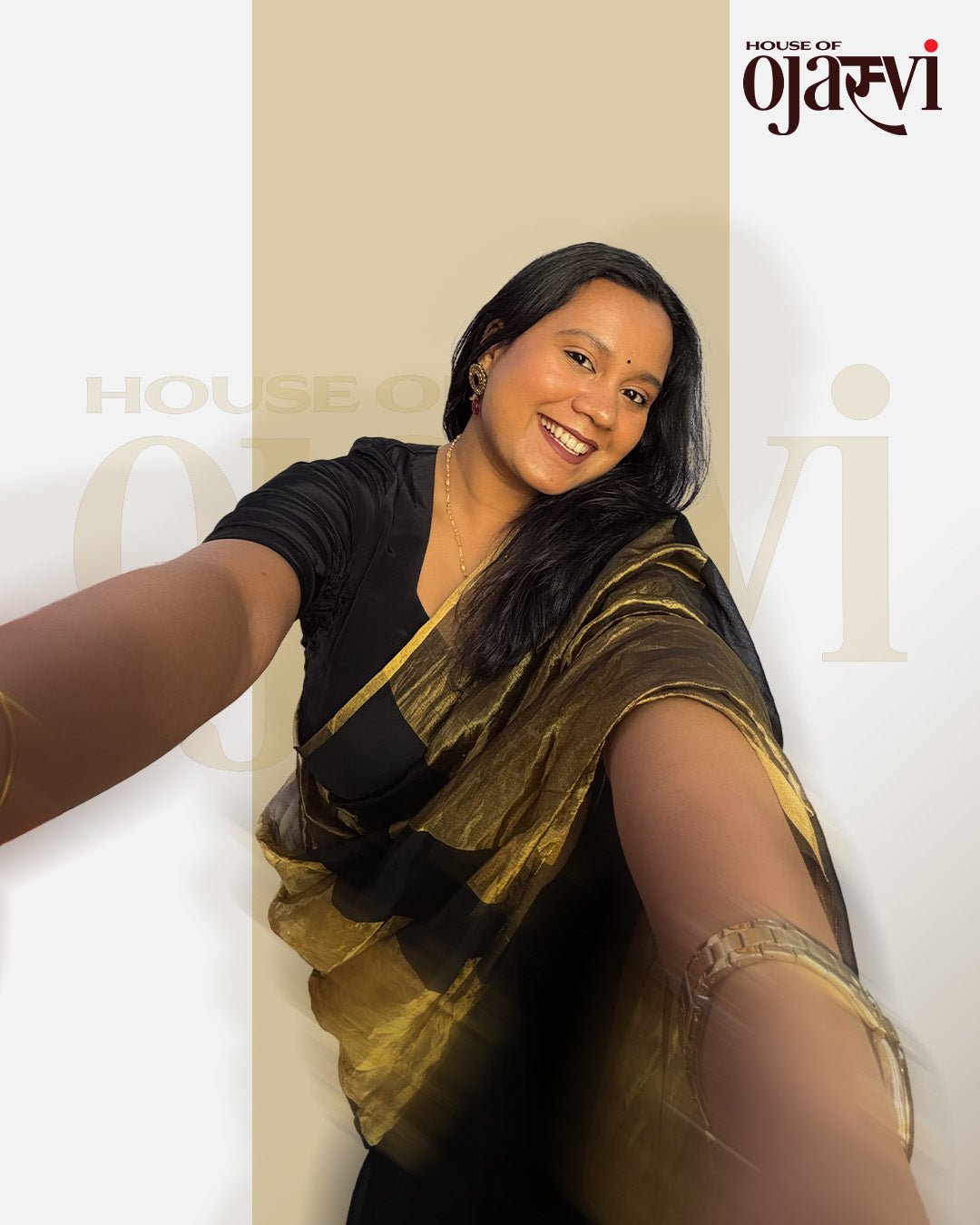 Close-up selfie style shot of the elegant black Chanderi saree with bold golden zari stripes by House of Ojasvi.