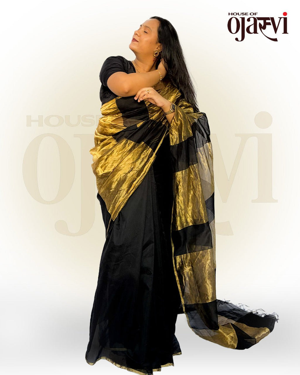 Side profile view showing the majestic drape of the bold golden zari striped pallu cascading down.