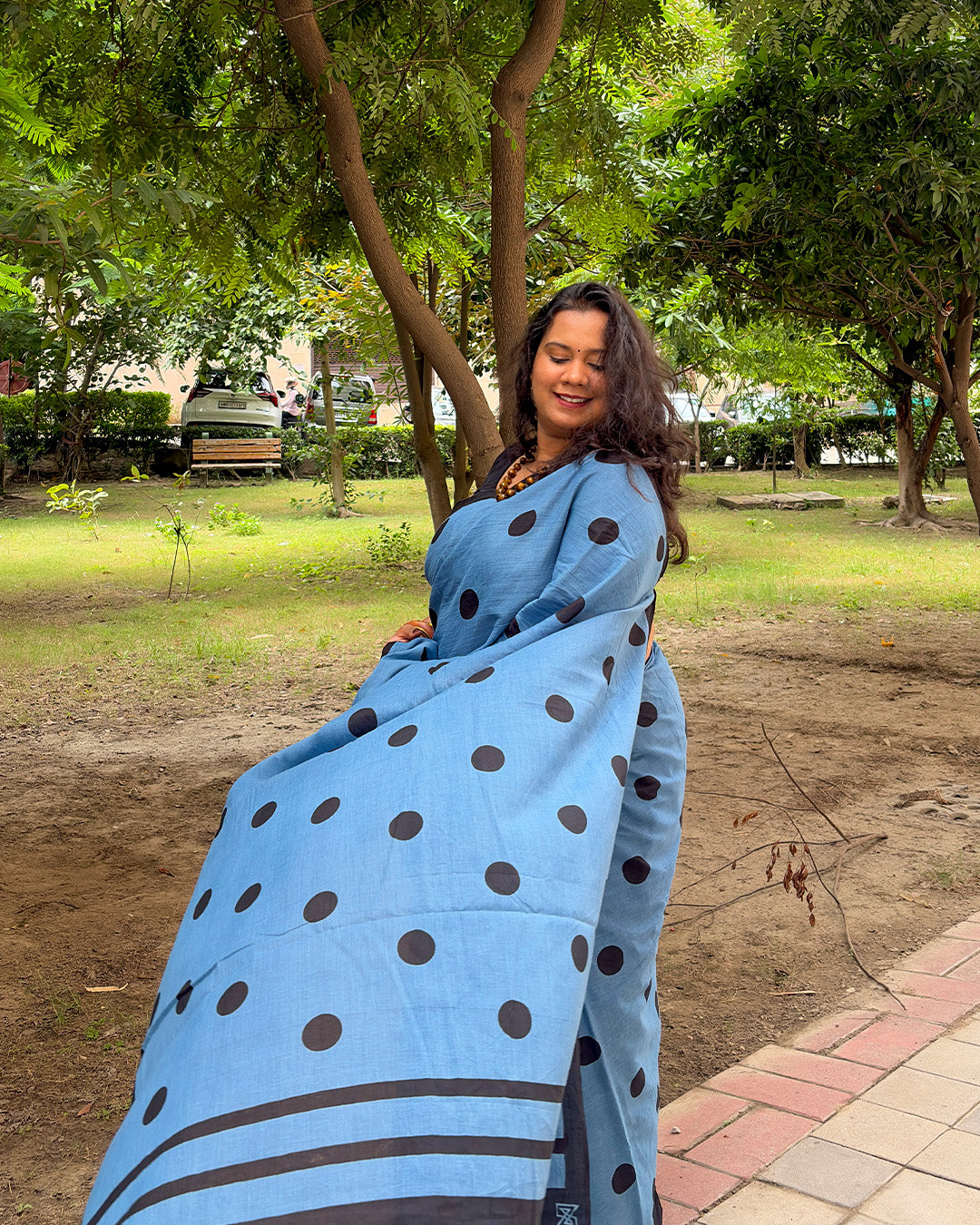 Full pallu drape view of the blue and black polka dot cotton handwoven saree highlighting the black triple-striped pallu edge