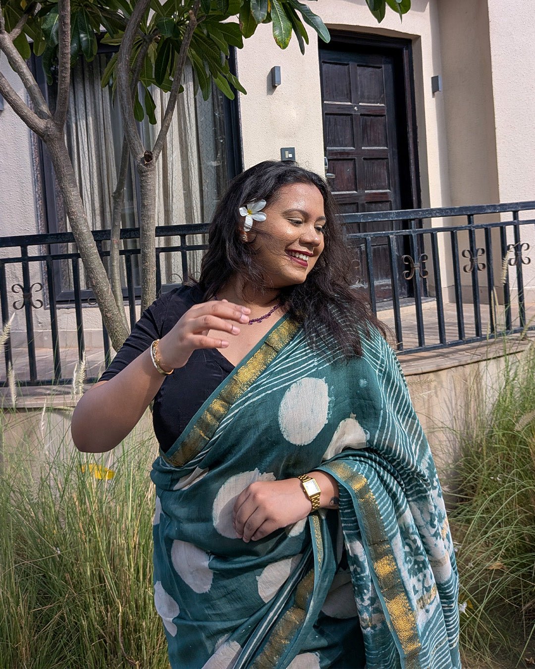 Full drape view of the dark green polka dot Maheshwari handwoven saree with traditional border details.