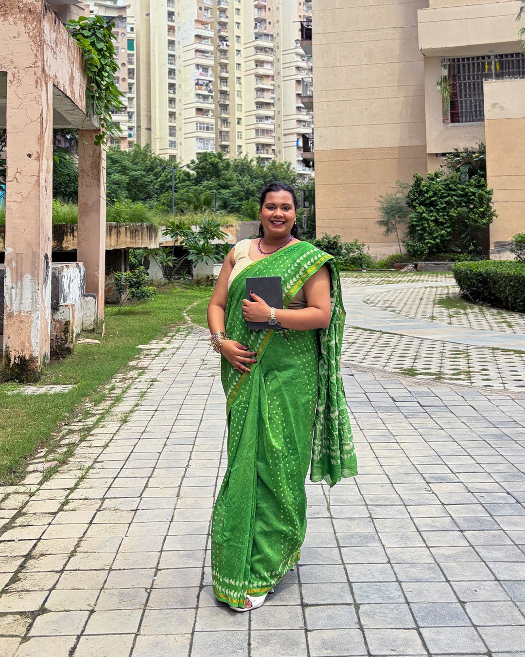 Model holding a notebook, showing the green Chanderi saree styled for a chic, everyday ethnic office look.