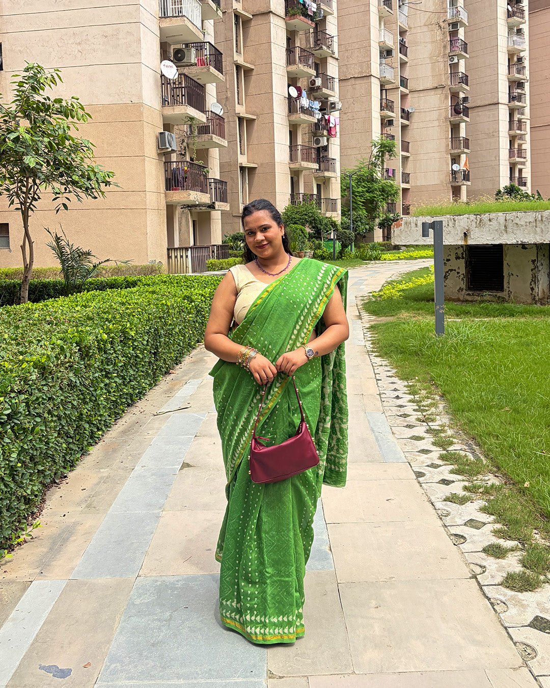 Full-length view showing the elegant drape of the green Chanderi saree with a contrasting cream blouse piece.
