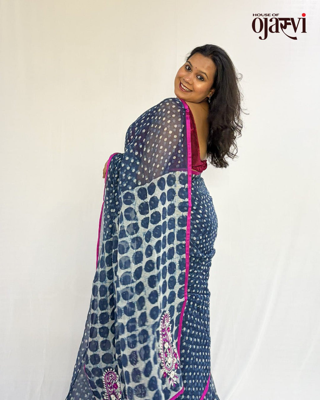 Model wearing the indigo polka dot handwoven Kota Doria saree with a pink border by House of Ojasvi.