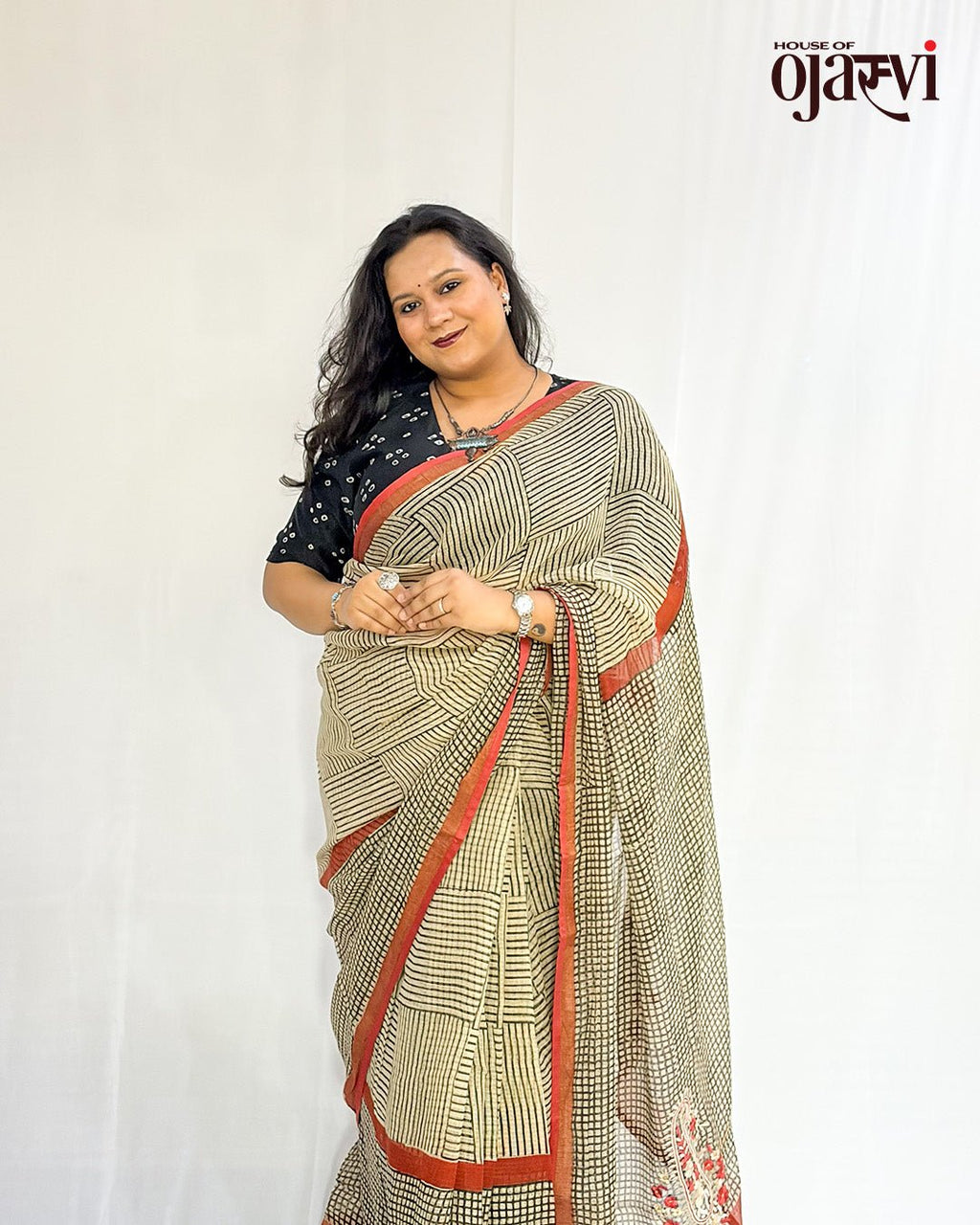 Side view of a handwoven Kota Doria check saree showing the red border and floral paisley motif at the pallu by House of Ojasvi