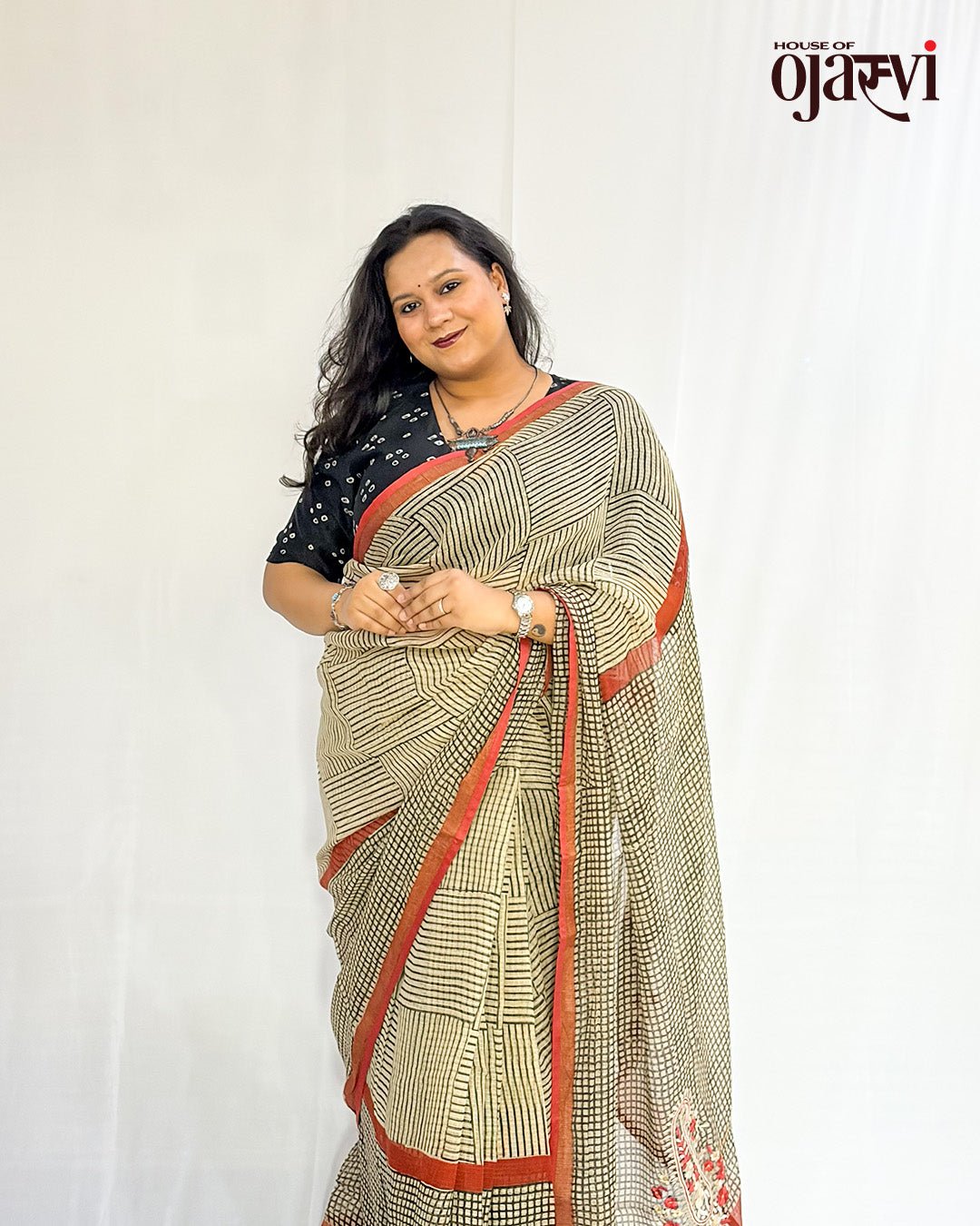 Side view of a handwoven Kota Doria check saree showing the red border and floral paisley motif at the pallu by House of Ojasvi