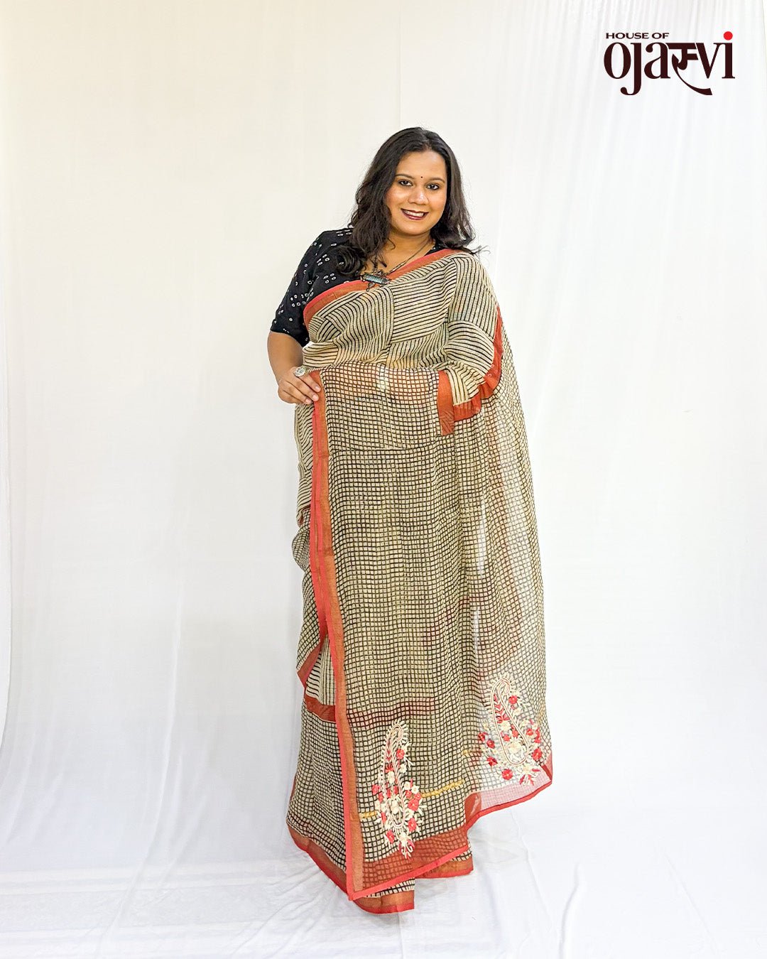 Close draped view of Kota Doria check saree showcasing embroidered paisley motifs and red border detail by House of Ojasvi