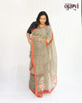 Woman wearing a beige and black check pattern Kota Doria handwoven saree with red border and embroidered paisley pallu by House of Ojasvi