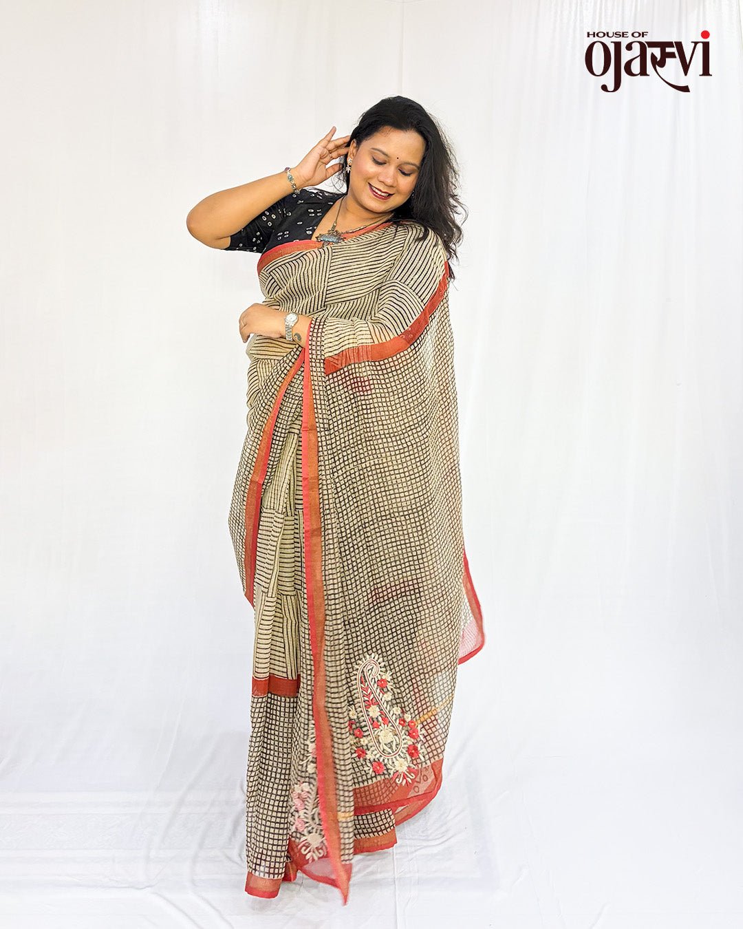 	Beige Kota Doria check saree with black checks and red border, draped with a black printed blouse by House of Ojasvi