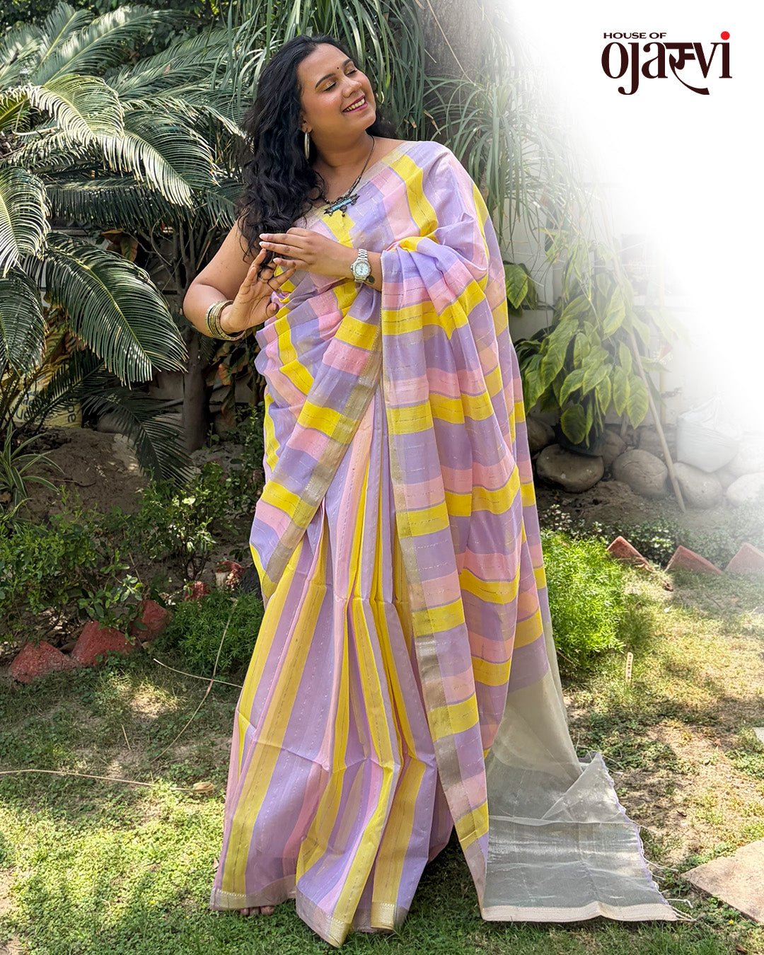 Outdoor garden lifestyle view of the lavender and yellow striped Maheshwari saree.