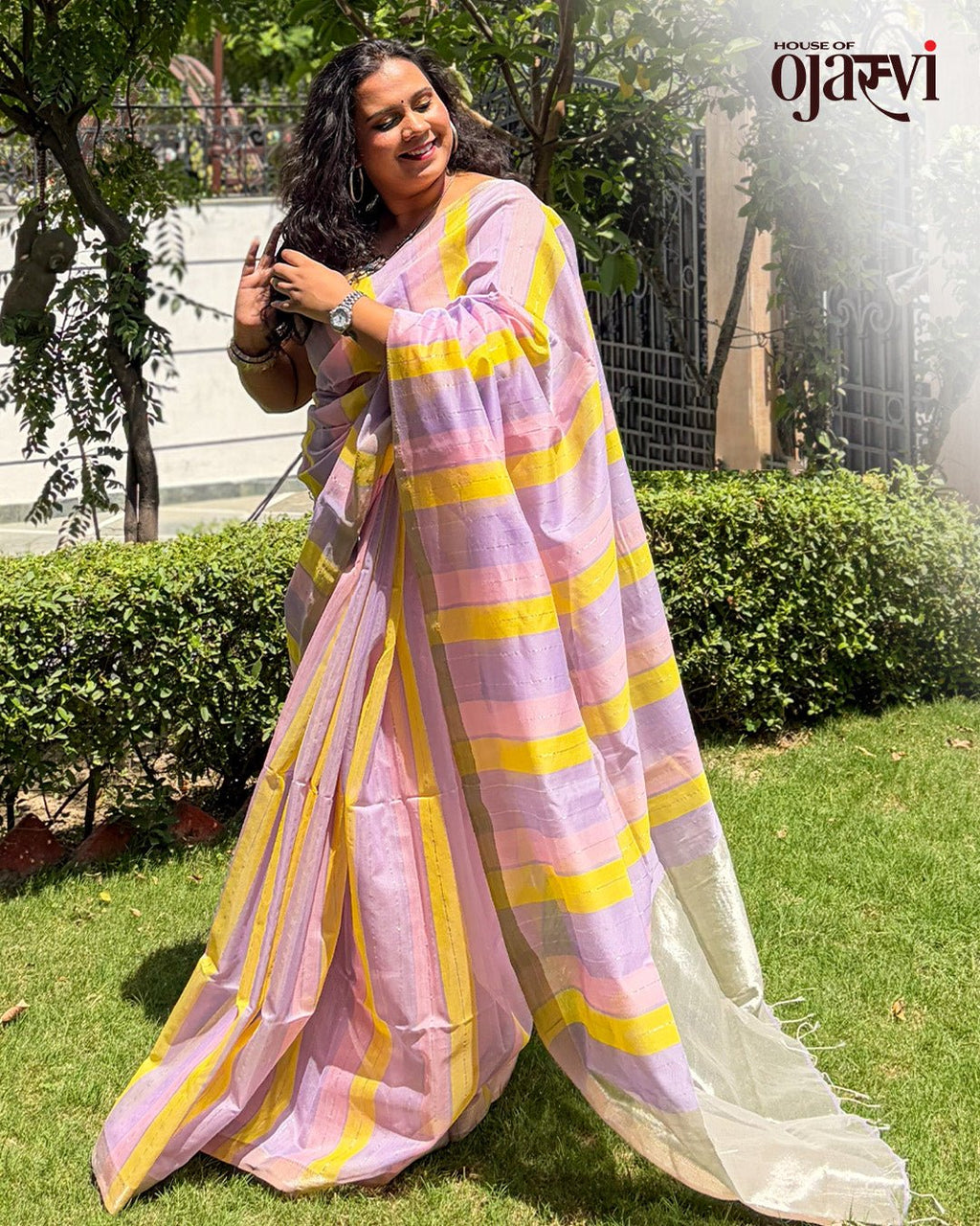 Styled view of a model in the pastel lavender and yellow striped Maheshwari handwoven saree.