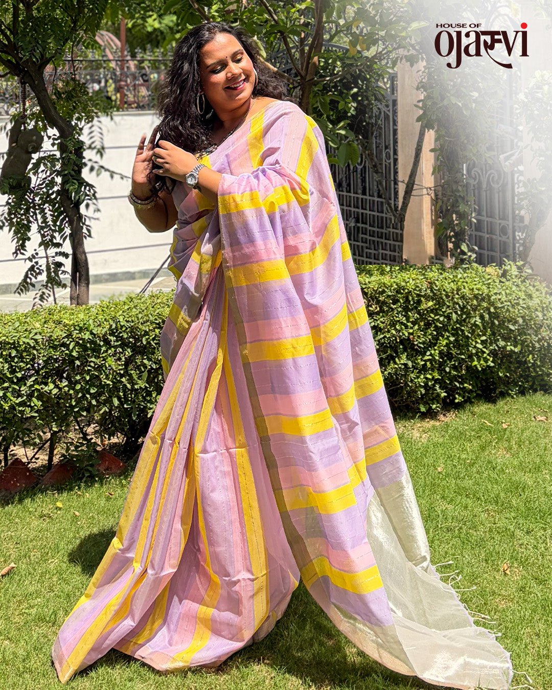 Styled view of a model in the pastel lavender and yellow striped Maheshwari handwoven saree.