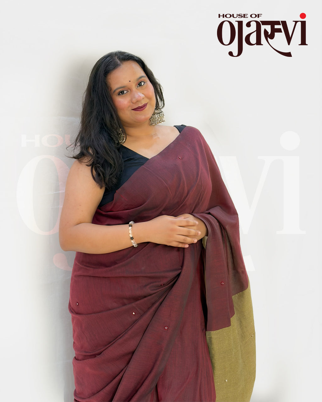Over-the-shoulder view of the maroon handwoven cotton saree showcasing the contrasting olive-gold textured pallu by House of Ojasvi