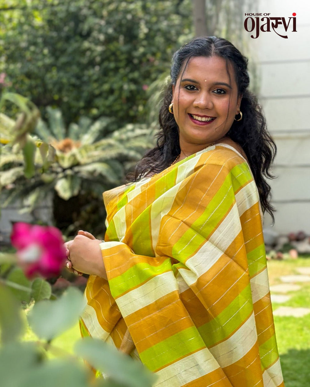 Close-up view of pleats on the orange and green striped handwoven Maheshwari saree by House of Ojasvi