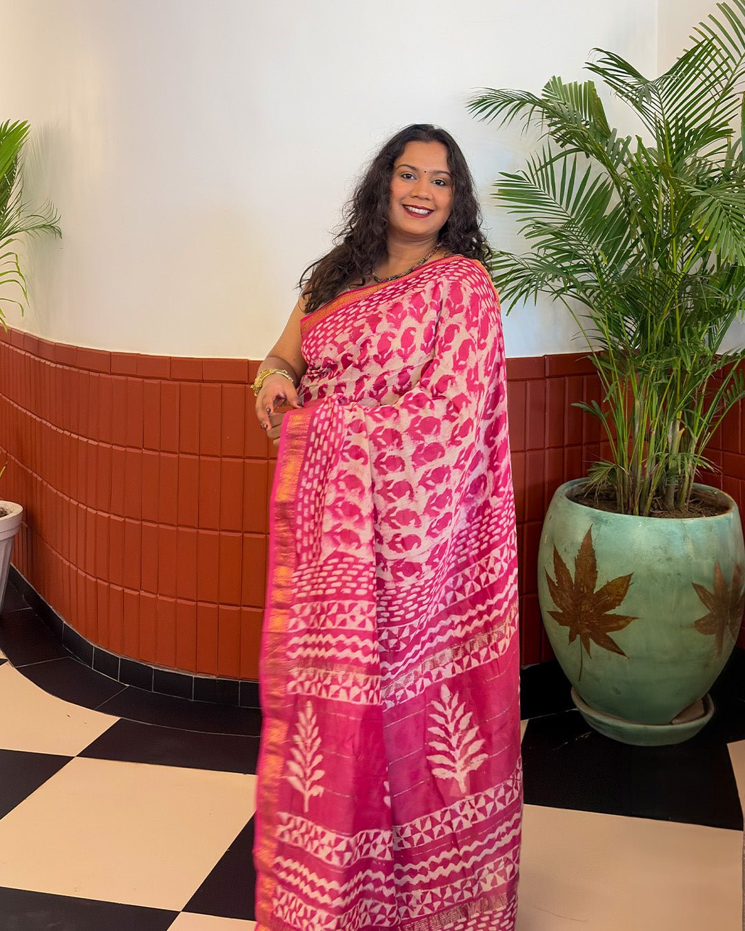 Back view highlighting the fluid drape and rich pink pallu of the Maheshwari handwoven saree