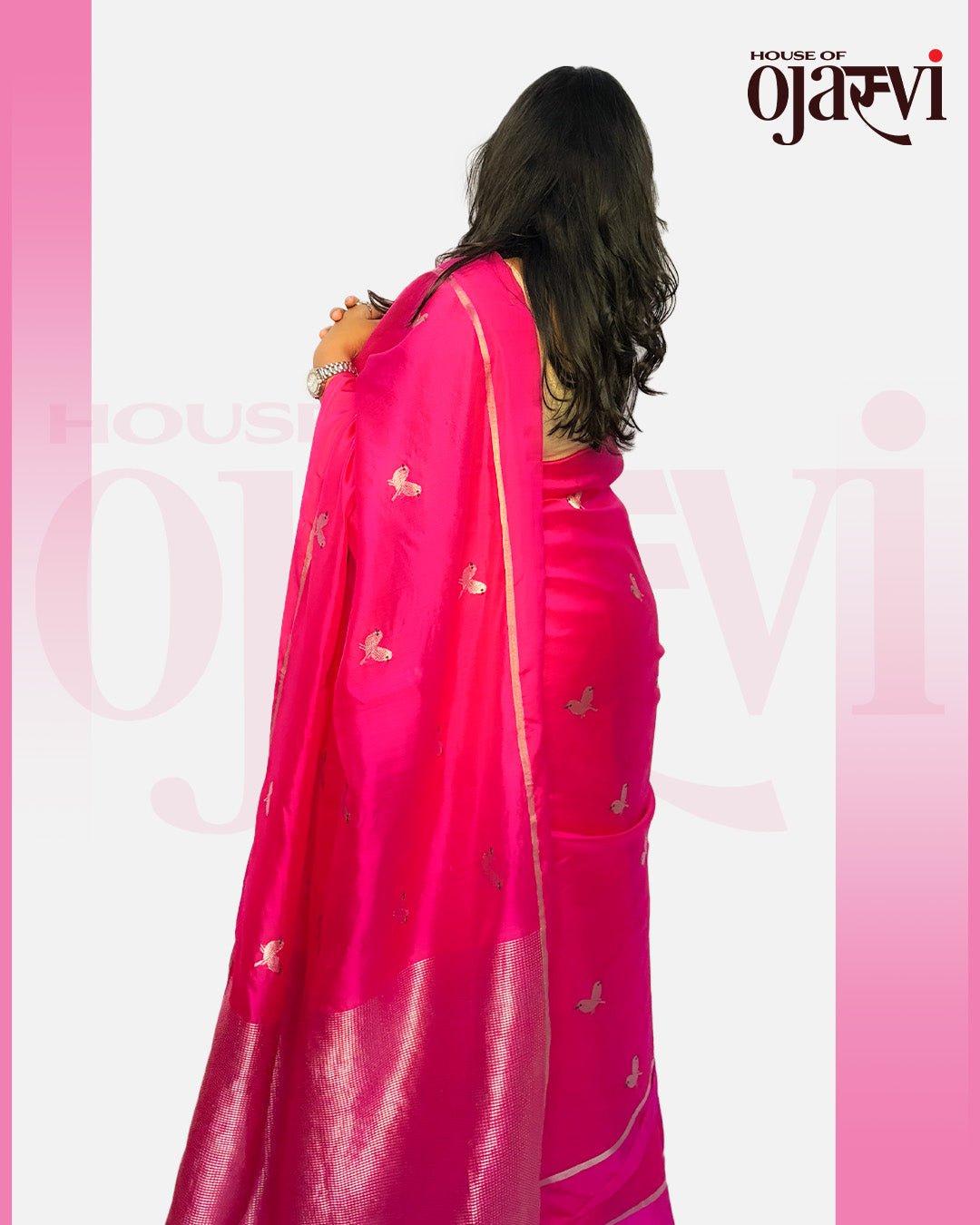 Back view showing the grand silver zari pallu drape on the vibrant pink Chanderi saree by House of Ojasvi.