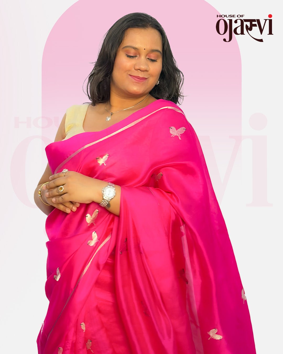 Elegant portrait of model wearing the pink Chanderi handwoven saree with silver butterfly motifs and cream blouse.