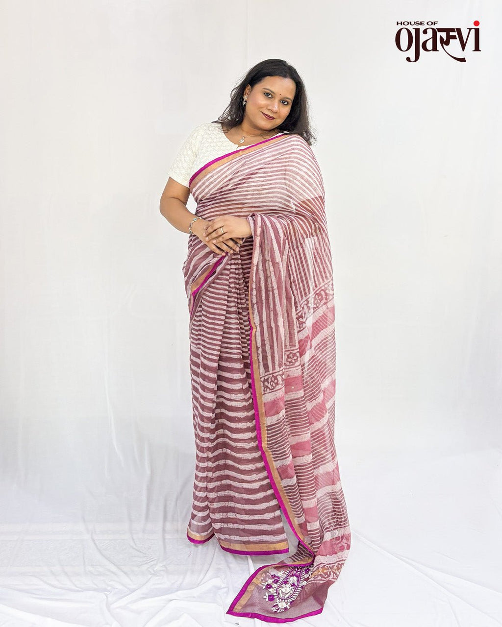 Side drape of a pink Kota Doria handwoven saree showing the striped body, printed pallu and embroidered paisley detail by House of Ojasvi