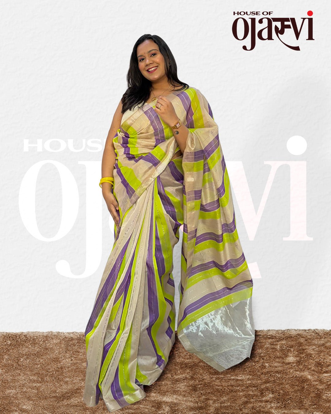 Full-length view of a model styling the purple and green striped Maheshwari handwoven saree.