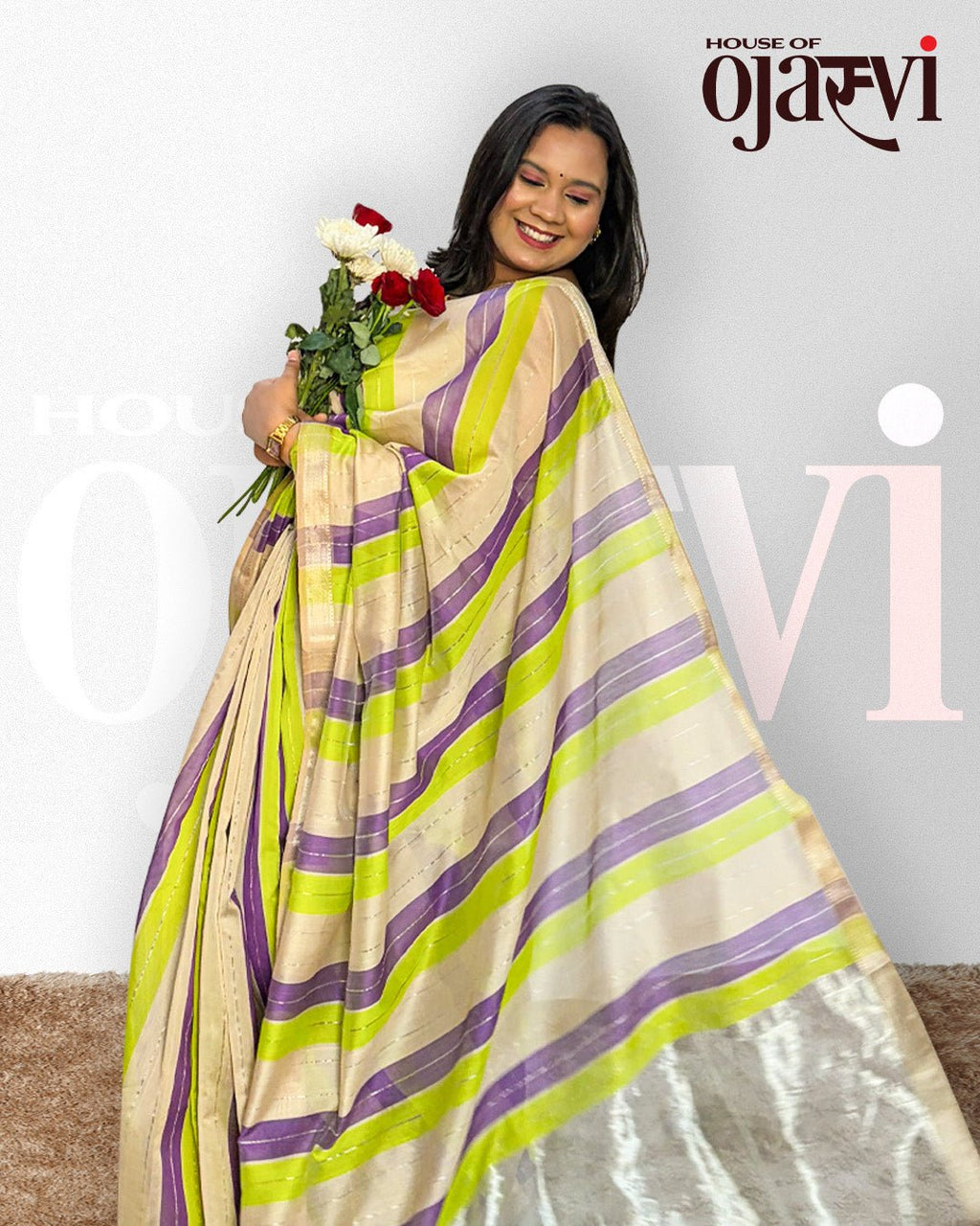 Model posing gracefully in the purple and green striped handwoven Maheshwari saree.