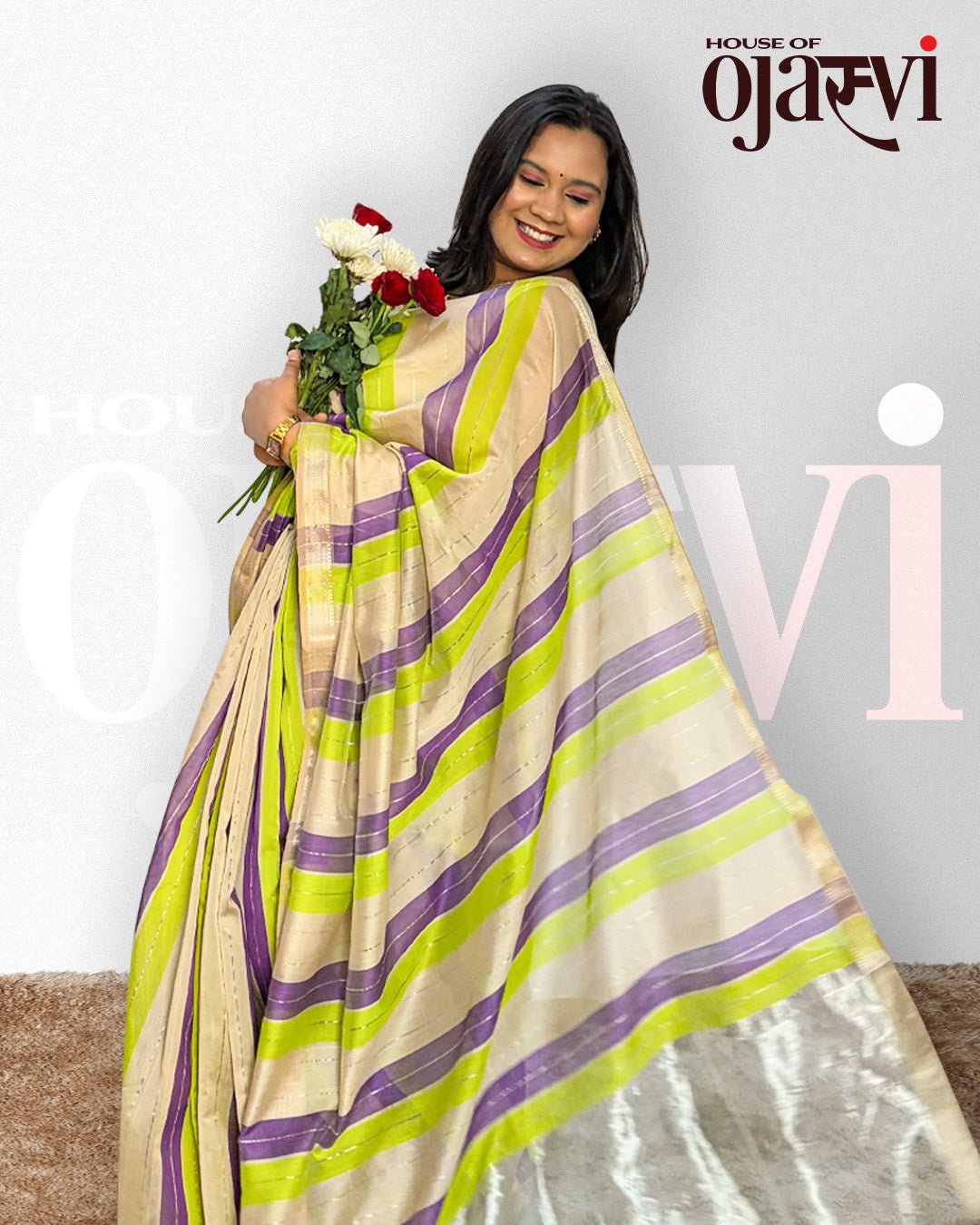 Model posing gracefully in the purple and green striped handwoven Maheshwari saree.