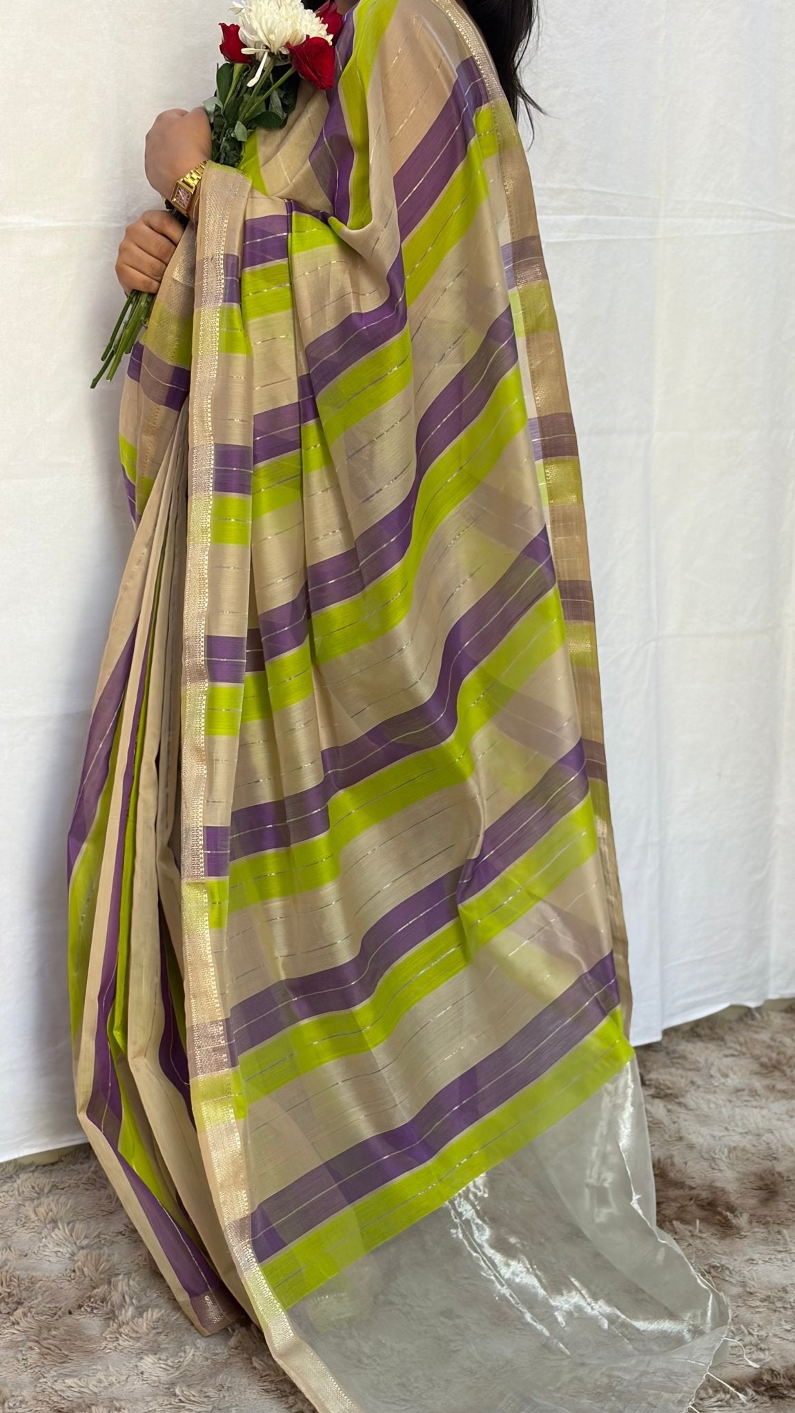 Full drape view of the purple, green, and neutral striped Maheshwari handwoven saree showcasing traditional zari borders.