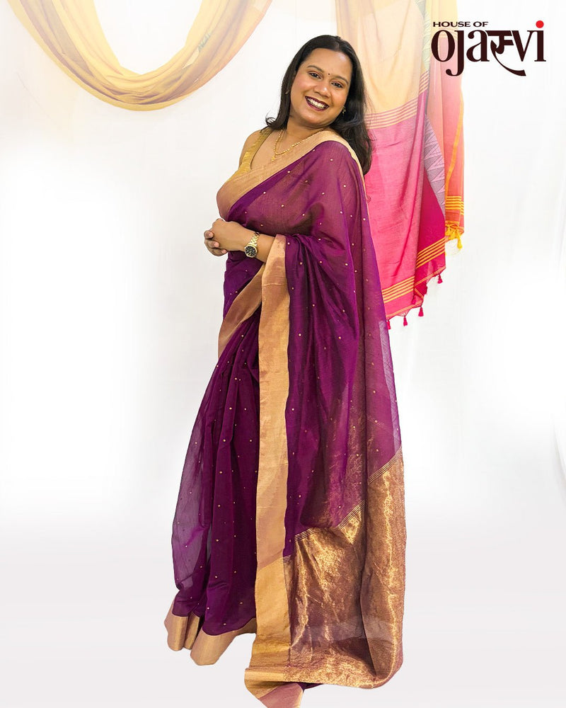 Smiling model standing in the royal purple Chanderi handwoven saree with golden zari border and butis by House of Ojasvi.