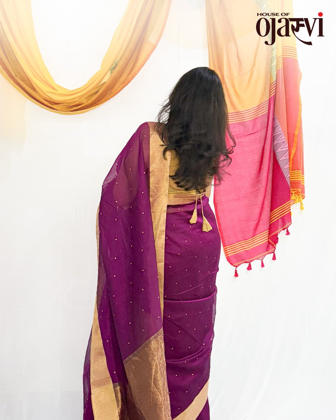 Back view showing the majestic golden pallu drape and the matching golden blouse on the purple Chanderi saree.